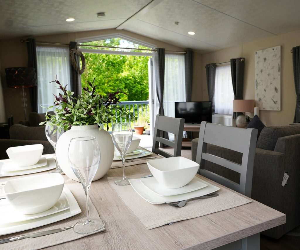 Dining area inside a lodge, showing the extra space of a lodge vs a static caravan