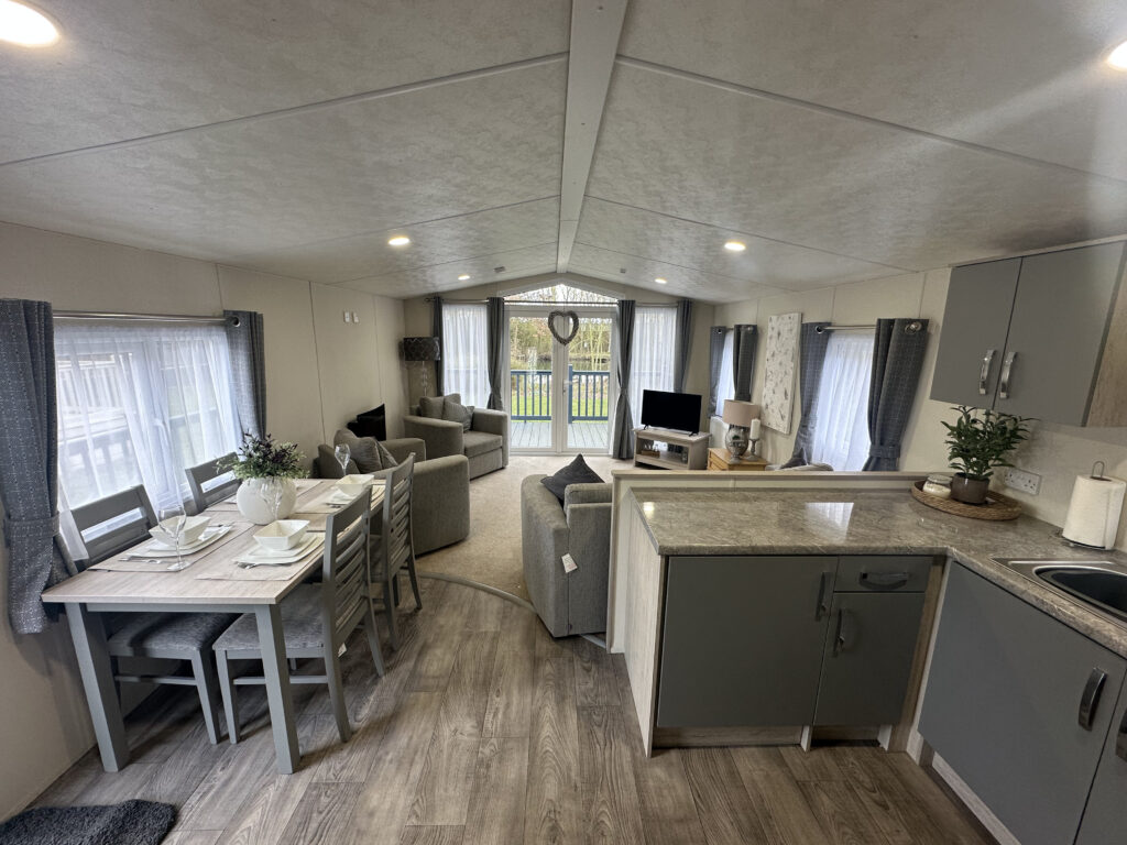 Open-plan lounge and kitchen in a holiday home for sale at Epworth Fields