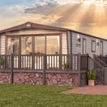 ABI Ambleside holiday home exterior with front French doors, wide windows and a raised deck with steps