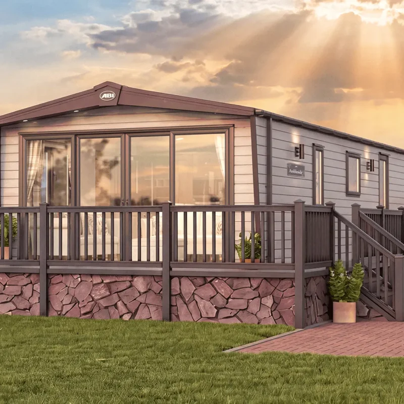 ABI Ambleside holiday home exterior with front French doors, wide windows and a raised deck with steps