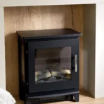 Close-up of the black wood-burner-style feature fire set in a light fire surround in the ABI Ambleside lounge