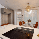 Induction hob on the Willerby Vogue kitchen island, looking across to the dining table and chairs by a window