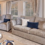Willerby Vogue lounge seating with a two-seater sofa, armchair and scatter cushions beside tall windows