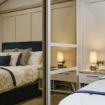 Willerby Vogue main bedroom with kingsize bed, bedside lamps and full-height mirrored sliding wardrobe doors